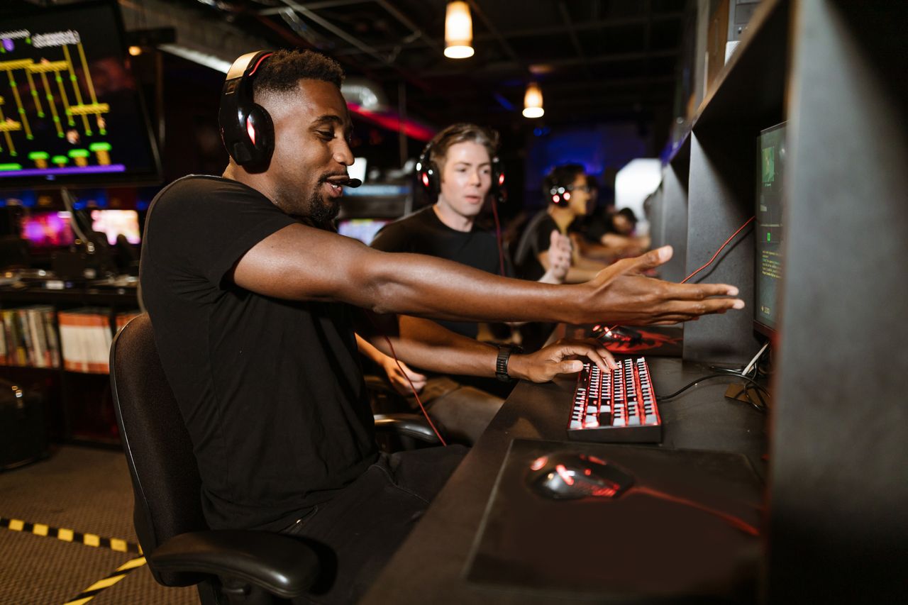 men enjoying a multiplayer gaming session in an arcade focused on e sp