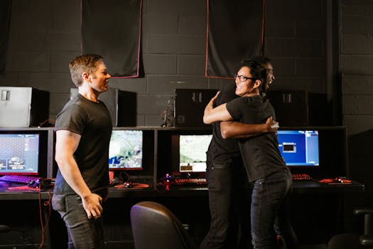 Young men celebrate a gaming win together in an eSport cyber cafe, exuding happiness and camaraderie.