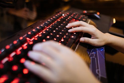 Selective Focus Photo of a Person's Hands on Mechanical Keyboard