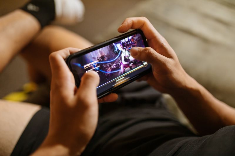 A person playing a mobile video game on a smartphone