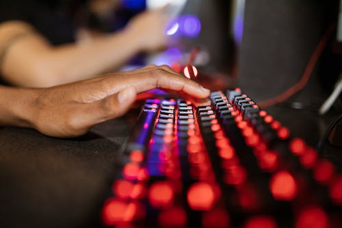 Selective Focus Photo of a Person's Hand on Mechanical Keyboard
