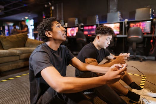 Two young men enjoying video games in an indoor arcade setting, highlighting diversity and friendship.