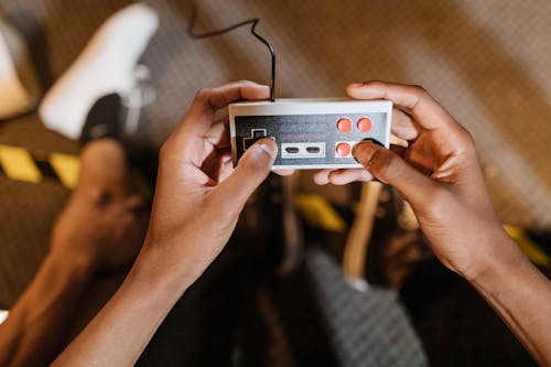 Free Close-Up View of a Person Holding a Game Controller Stock Photo