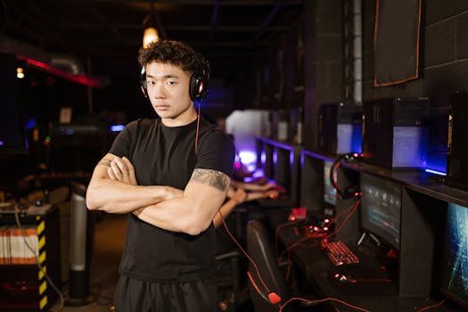 A confident gamer stands in a modern eSports arena, showcasing the gaming environment.