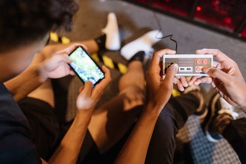 Close-Up View of Two People Playing a Video Game