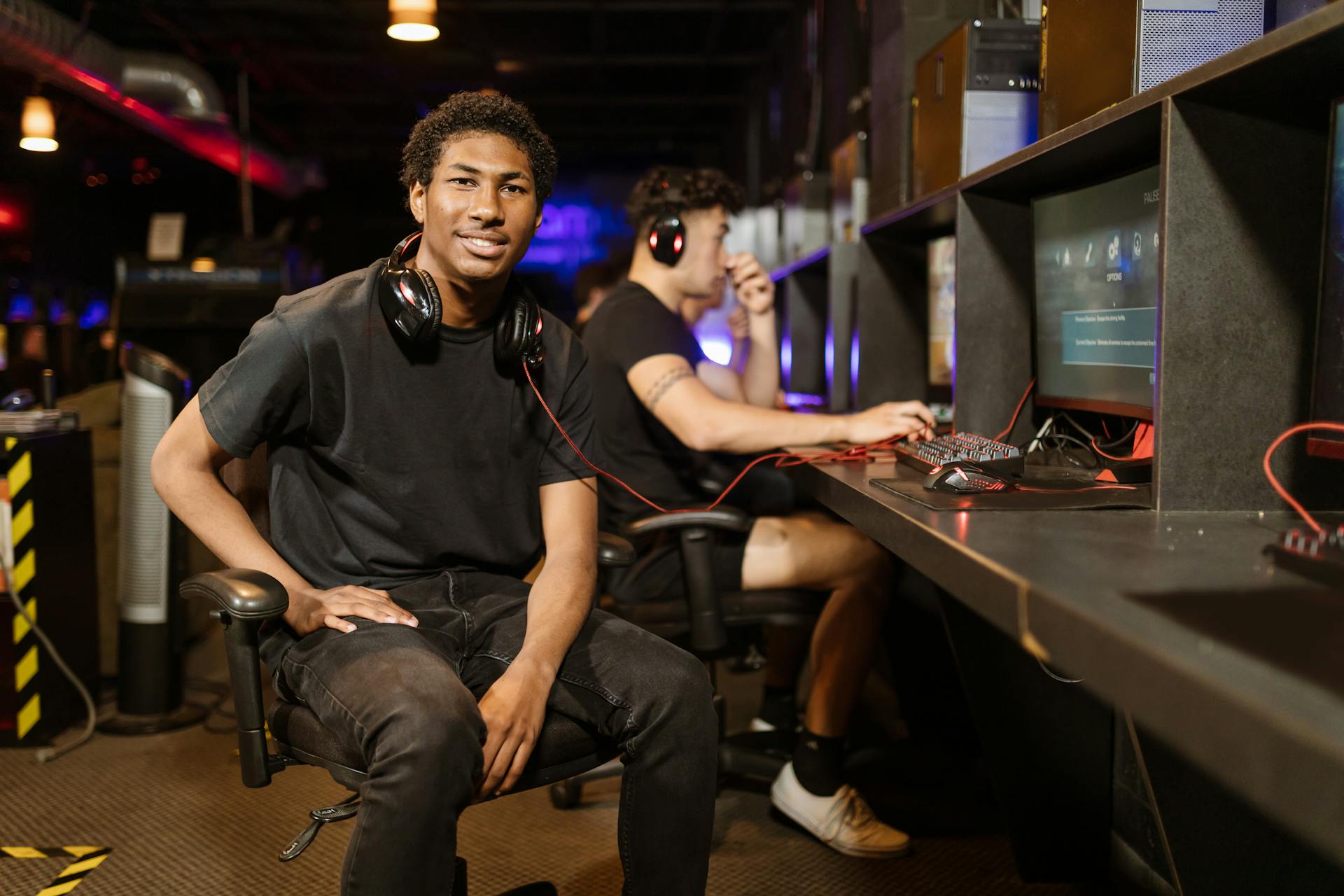 Two gamers playing at a modern gaming station, highlighting technology and e-sports.