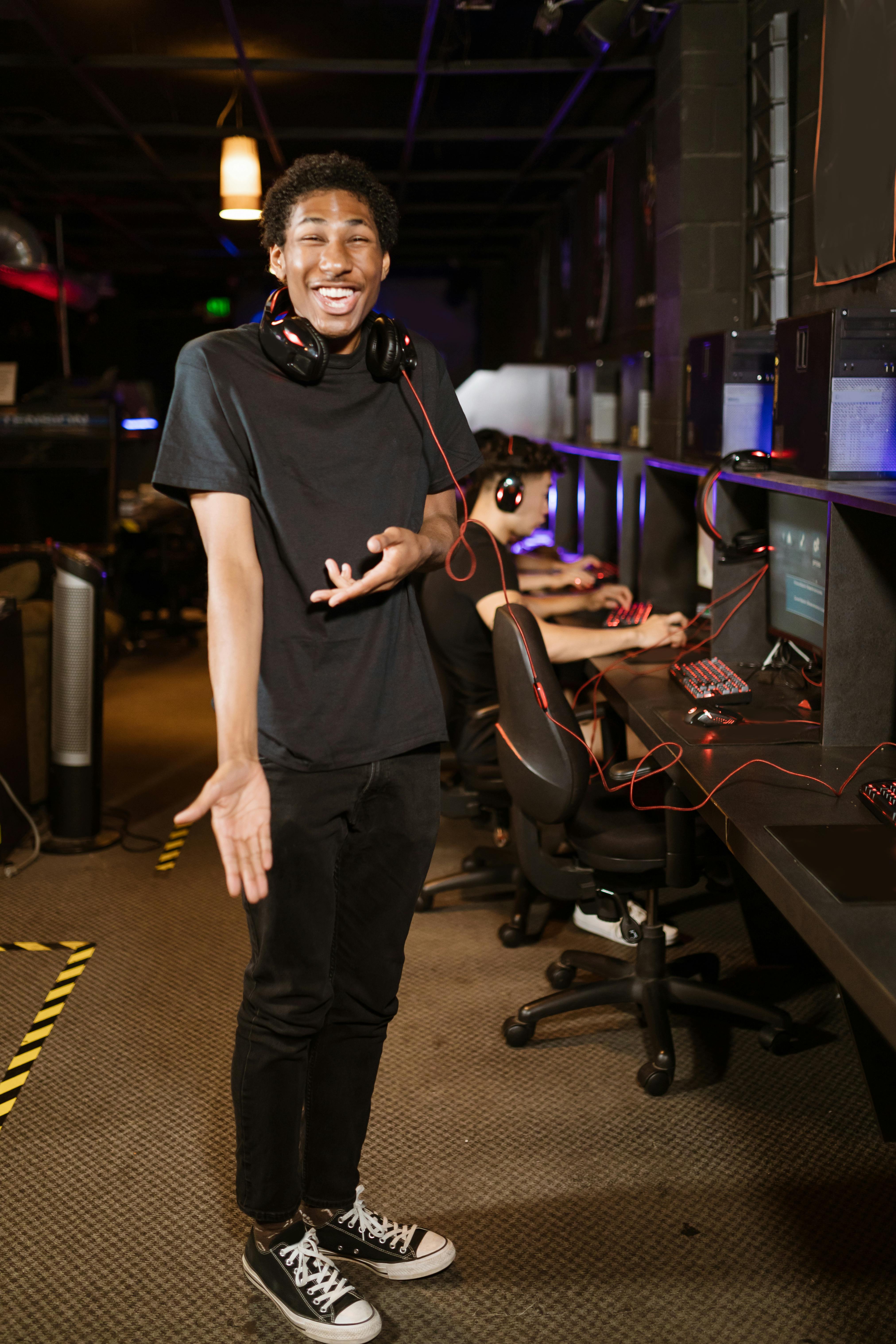 man in black shirt wearing black headphones while smiling