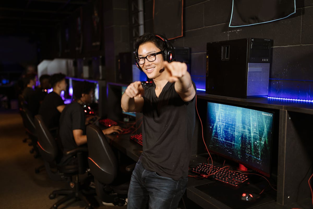 Player using a game controller while looking at a farming simulation on a monitor