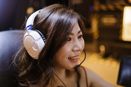 A woman enjoying gaming with headphones, expressing fun and excitement.