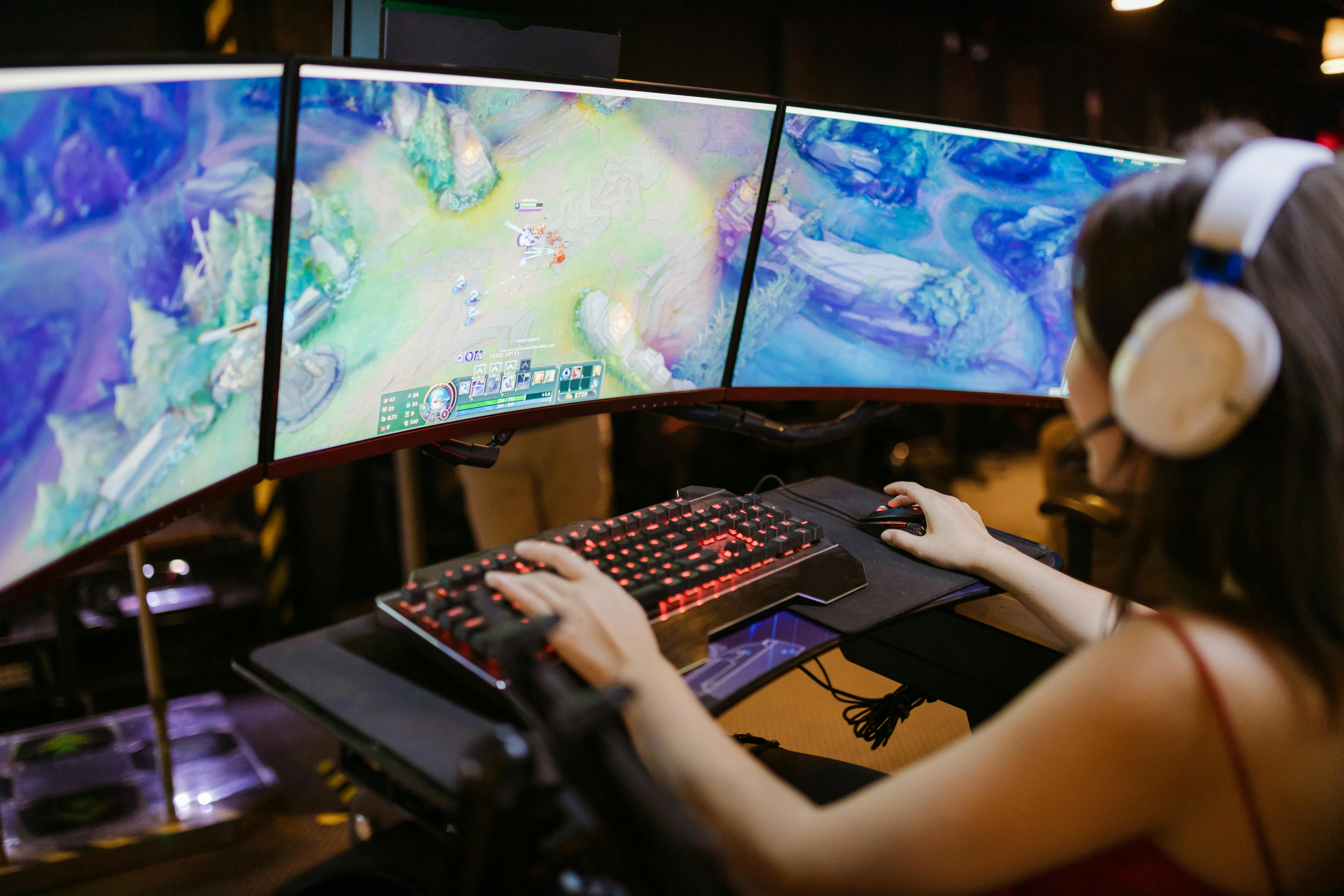 Person playing video games with controller on computer Stock Photo