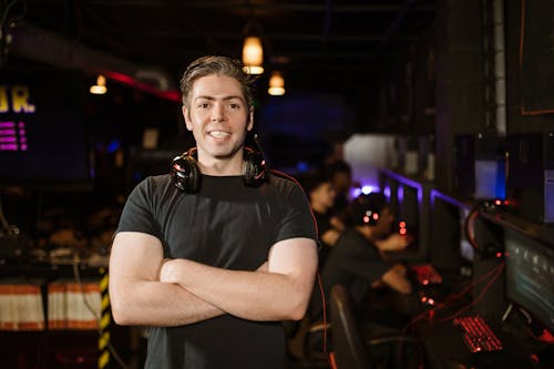 Free Man in Black Shirt Wearing Black Headphones while Smiling Stock Photo