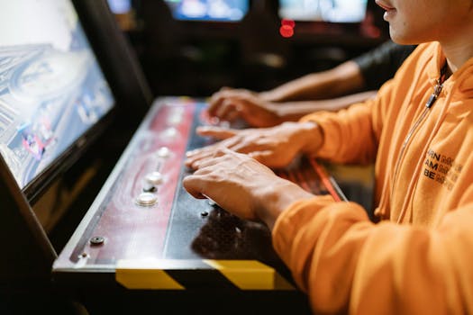 Close-up of hands at an arcade machine. Engaging in gaming, technology and recreation.