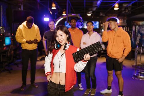 A Woman Smiling while Holding a Black Keyboard