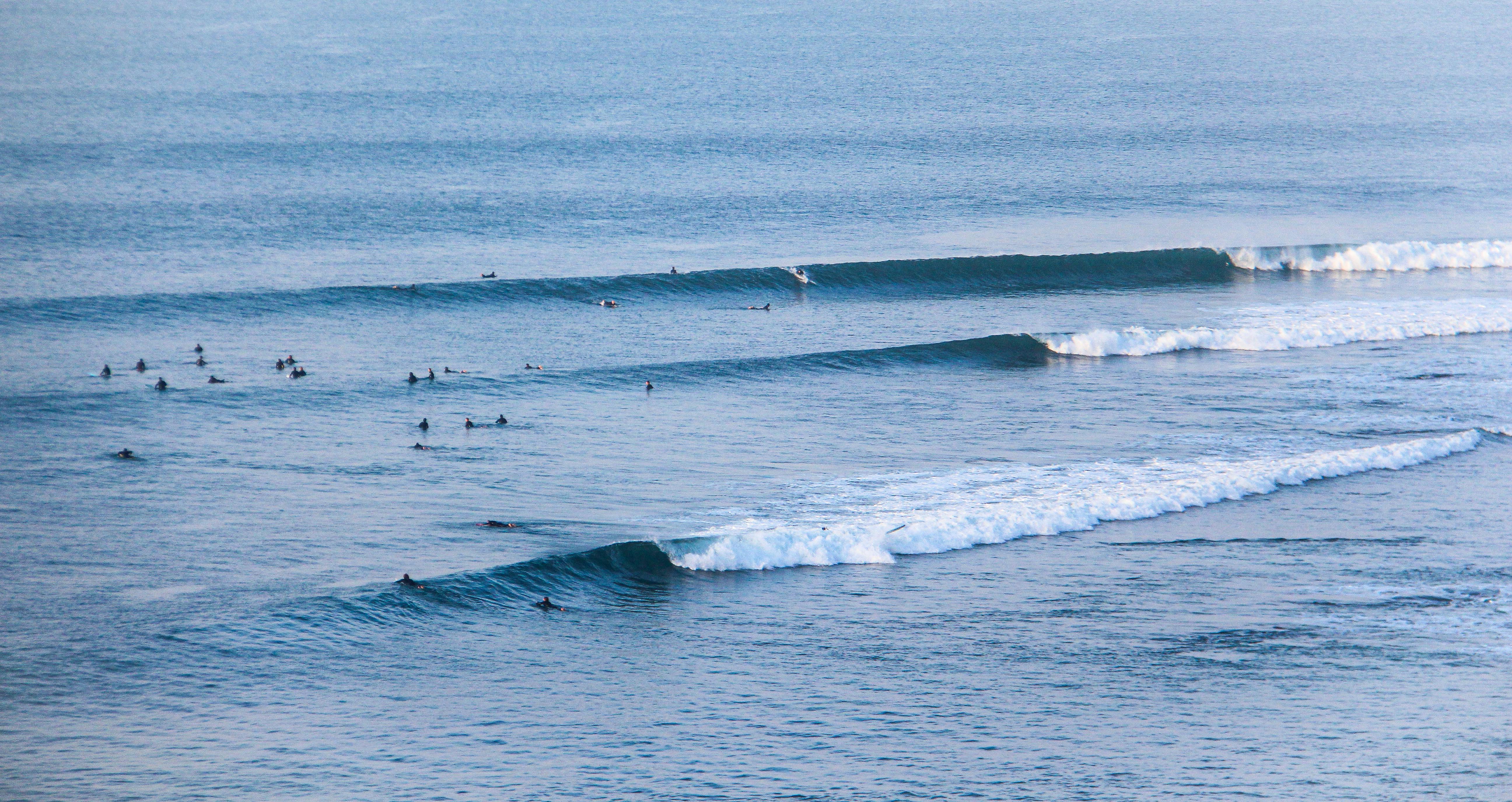 A person playing a tactical role-playing game on a computer in a dark room.