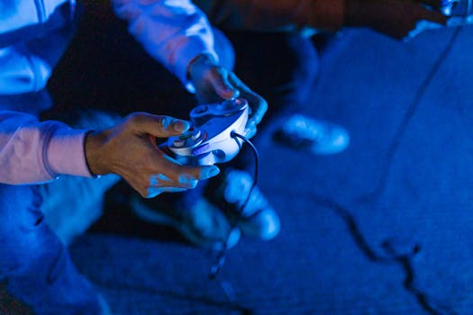 Close-up of a person gaming with a controller, illuminated by blue light, emphasizing e-sports culture.