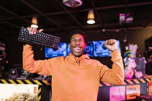 Man in Orange Jacket Looking Excited