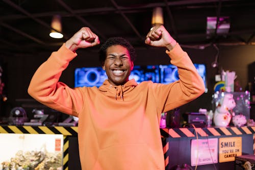 Free Man in Orange Jacket Looking Excited Stock Photo