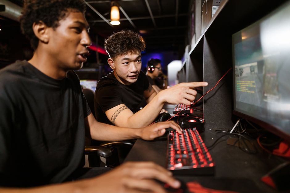 A group of diverse young men enjoying a gaming session indoors, highlighting friendship and modern technology. A group of diverse young men enjoying a gaming session indoors, highlighting friendship and modern technology.