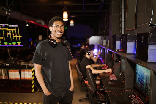 Cheerful young man with headphones in a vibrant gaming center, enjoying the atmosphere.