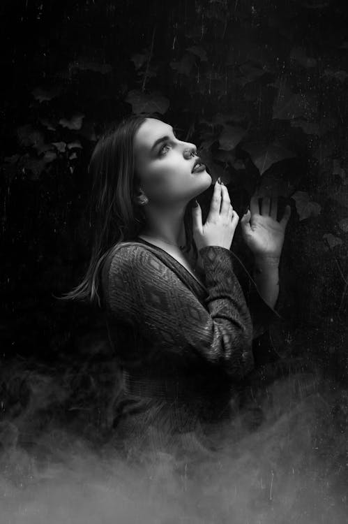 Black and White Photo of a Woman with Smoke Below Her · Free Stock Photo