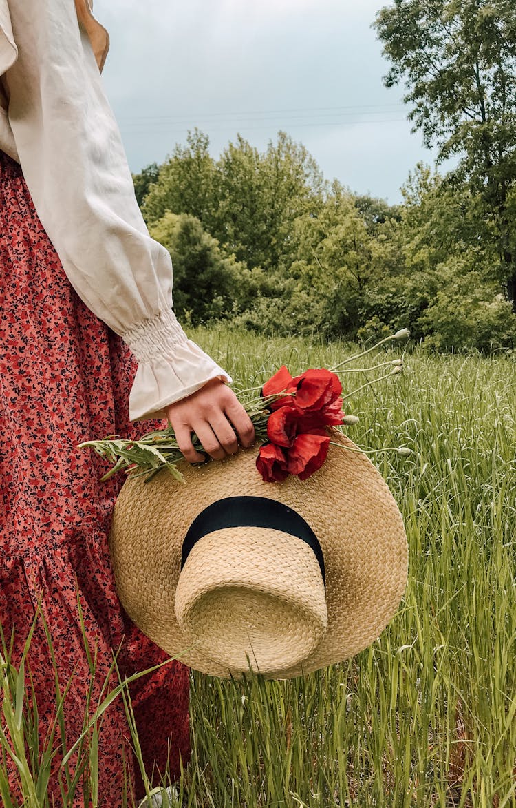 Woman With Hat And Flowers In Field