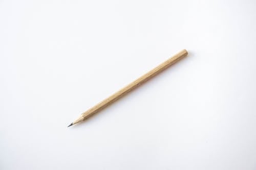 A Wooden Pencil on White Surface