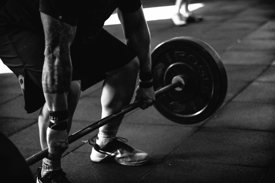 Man Carrying Barbell 