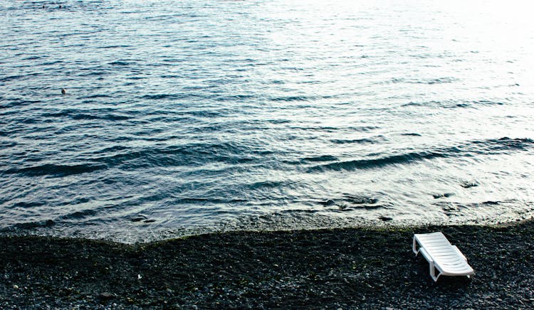 White Lounge Chair On Beach