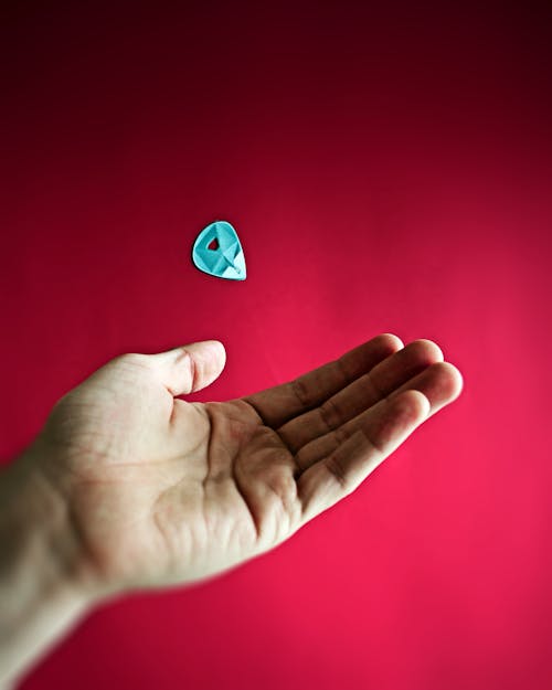 A Person's Hand Near the Guitar Pick