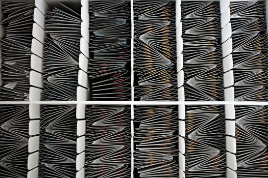 Neatly organized documents divided by separators, seen from above.