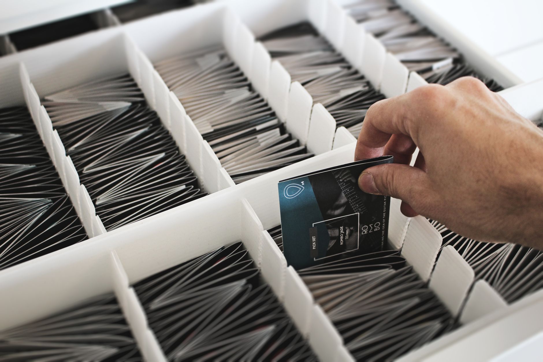 organized football card collection in labeled boxes, rookie cards and parallels sorted by team