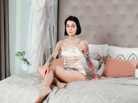 A Woman Sitting on Bed in a Nighties