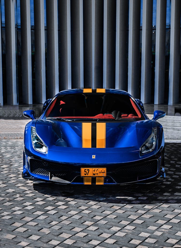 A Blue Ferrari Parked In A Parking Lot