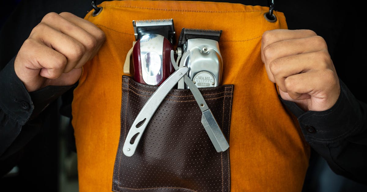 Close-up of barber tools in an apron pocket, showcasing professionalism and readiness.