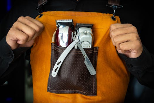 Close-up of barber tools in an apron pocket, showcasing professionalism and readiness.
