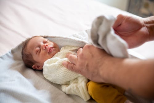 Free A Baby in White Knitted Shirt Stock Photo