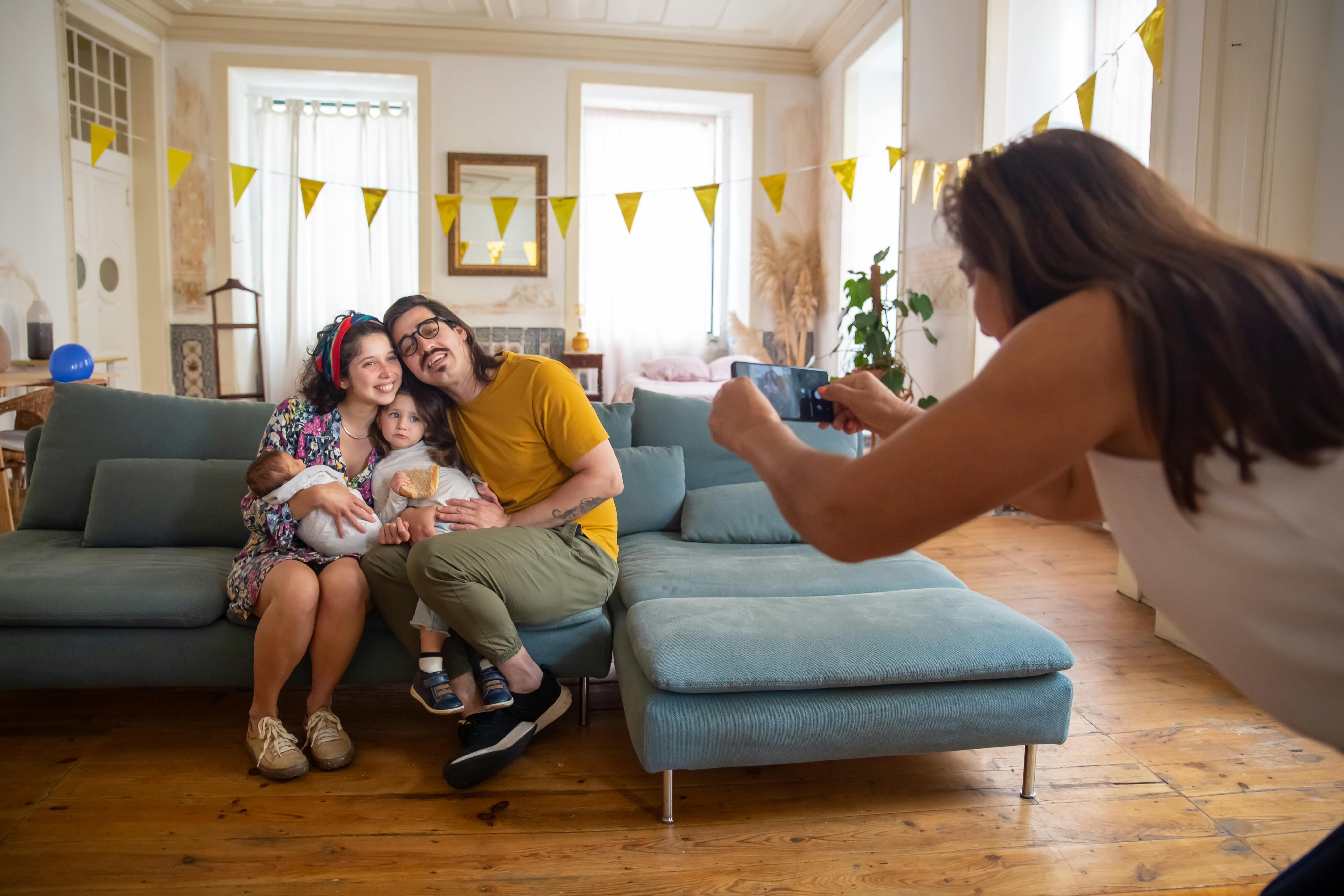 A Family Sitting On The Couch Free Stock Photo   Pexels Photo 7919631 