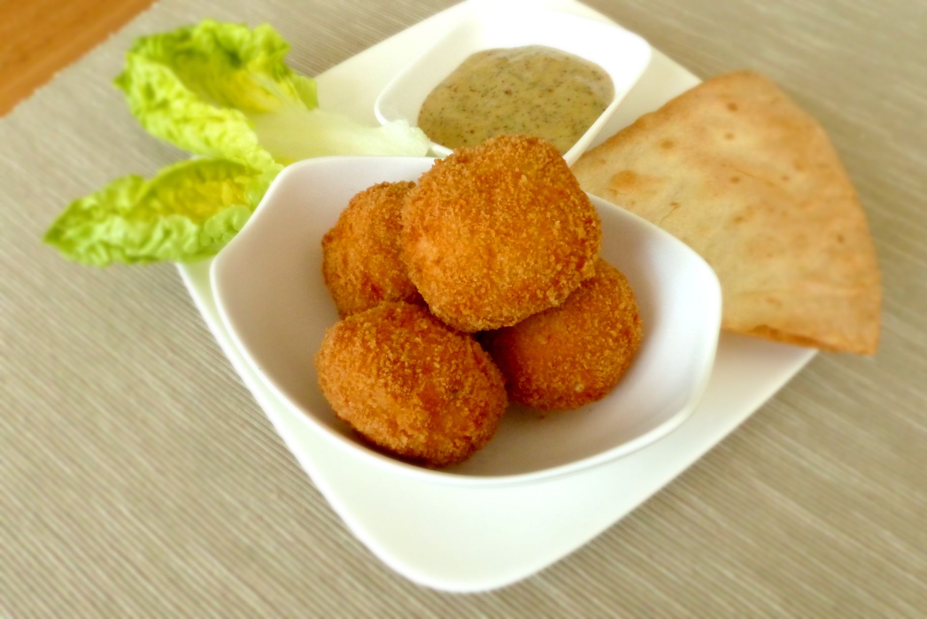 Close-up of crispy Deez Ain’t Gator Bites with swamp sauce