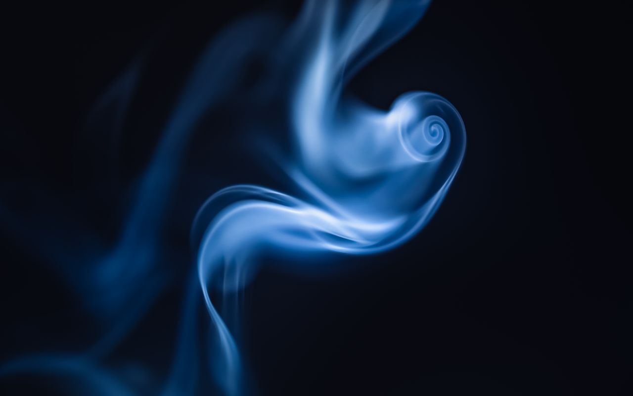 ethereal blue smoke swirl gracefully against a dark backdrop creating
