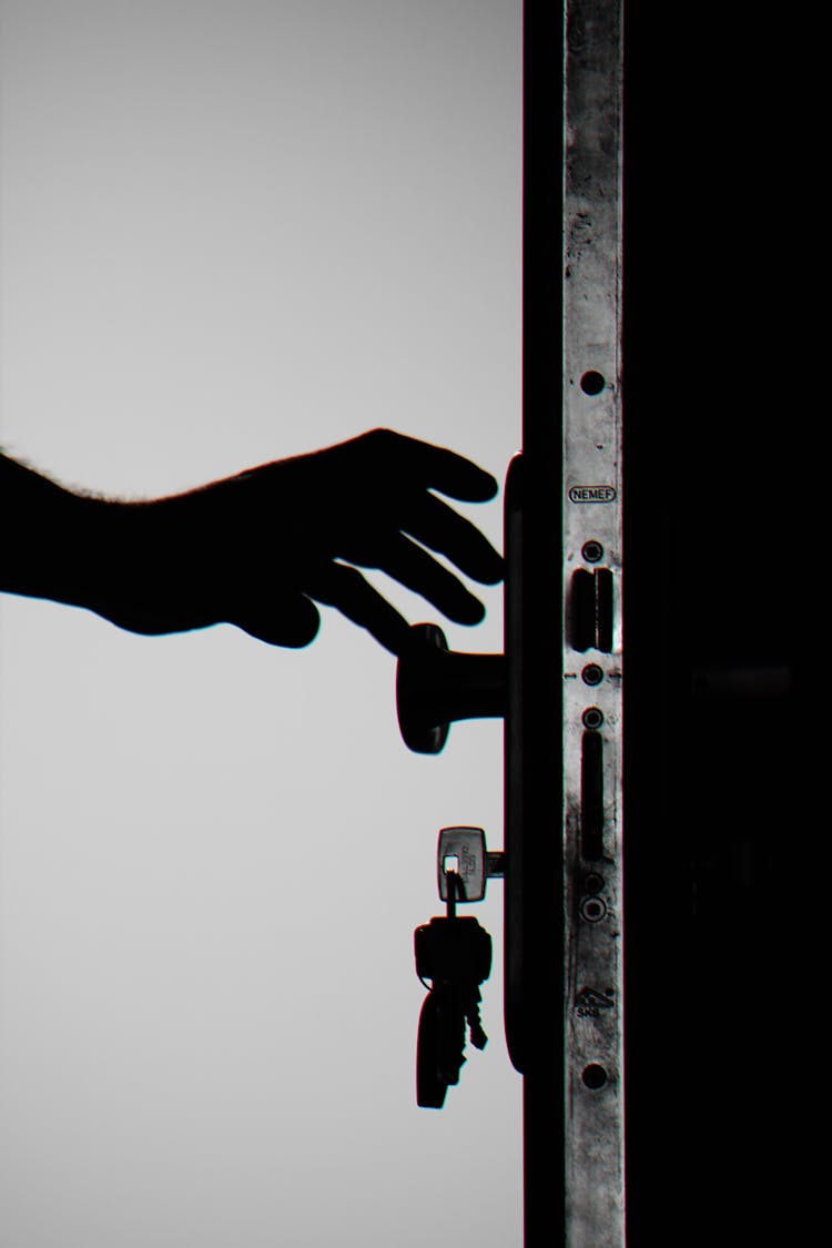 Silhouette Photo Of Person Holding Door Knob