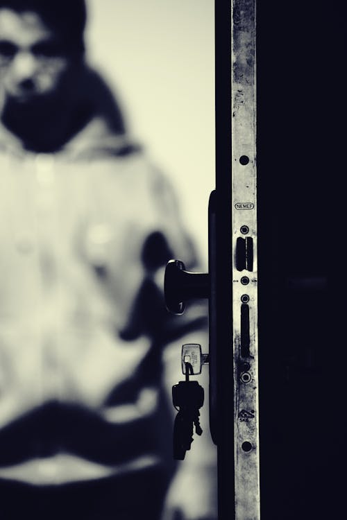 Monochrome Photo of Keys and Door Knob