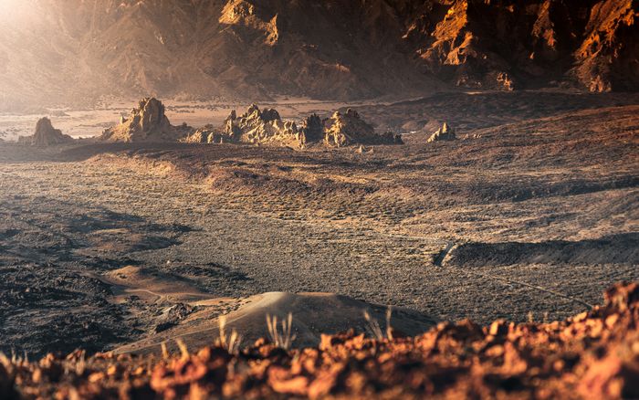 Breathtaking view of Mars-like volcanic terrain under warm sunrise light in Tenerife's nat, by Marek Piwnicki on Pexels