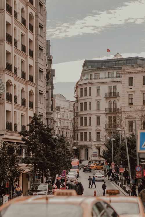 Free Urban scene in Istanbul with buildings, cars, and people on a busy street. Captivating city life in Turkey. Stock Photo