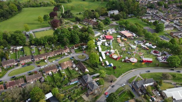 Aerial shot of a fairground amidst homes in Houghton Regis, England.
