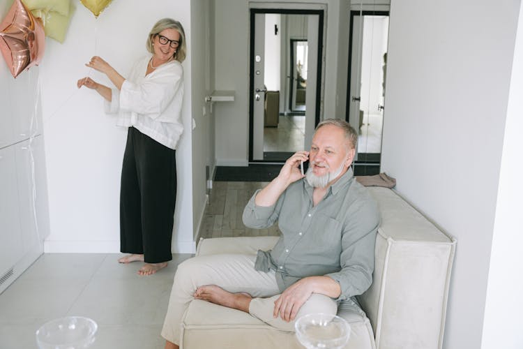 An Elderly Couple Having A Phone Call