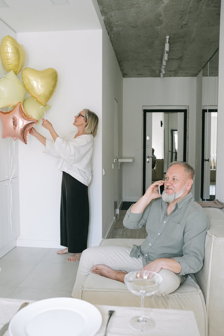 An Elderly Couple Having A Phone Call