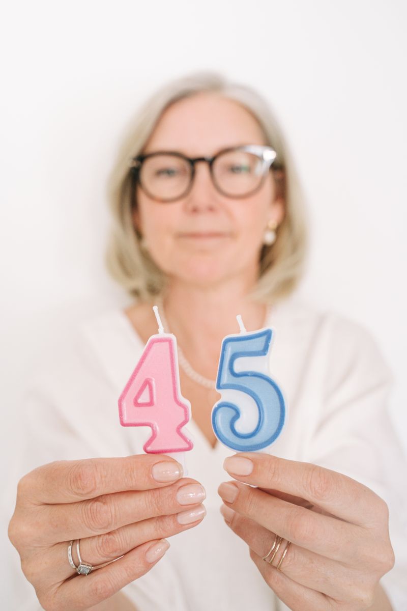 Warm candid moment of guest holding candles at a birthday celebration