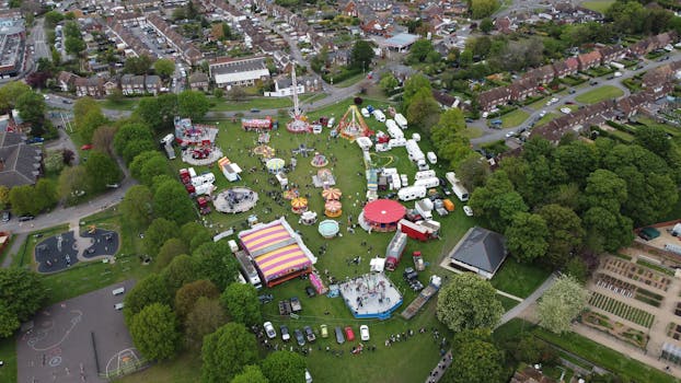 Aerial photograph showcasing a vibrant amusement park in Houghton Regis, surrounded by lush greenery.