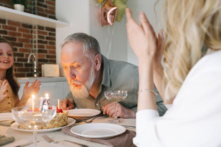 Bearded Man Blowing A Cake