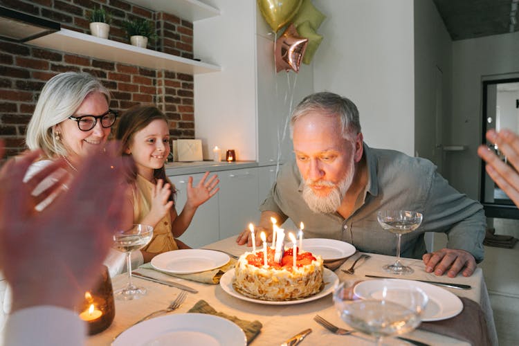 Man Blowing Candles